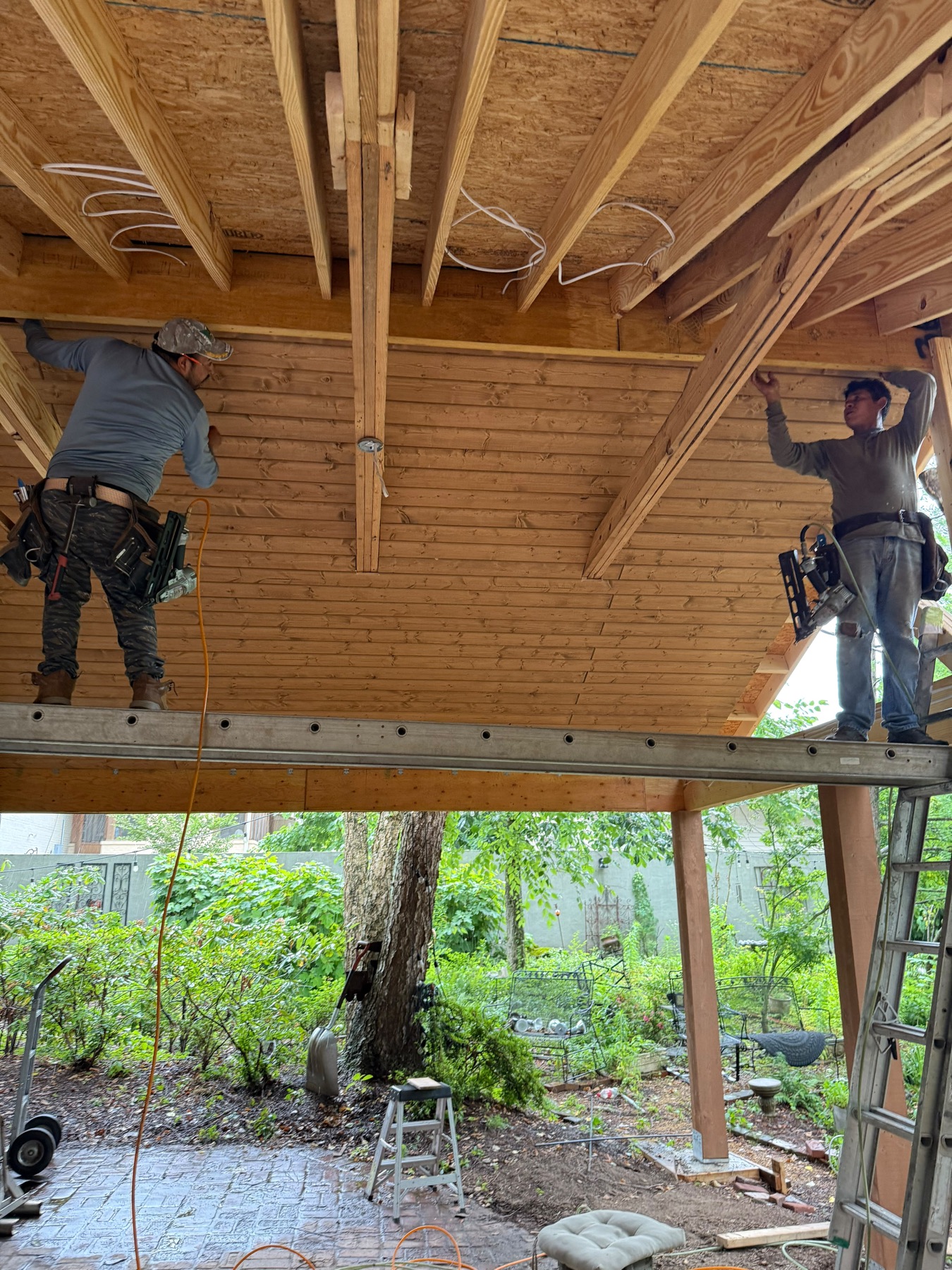 Crew installing wood ceiling